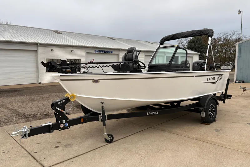 Slide: The Image of 2026 Lund 1800 Explorer Sport boat on trailer outside showroom. - 5