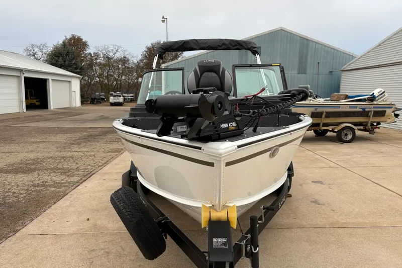 Slide: The Image of 2026 Lund 1800 Explorer Sport boat on trailer, equipped with Minn Kota trolling motor. - 6