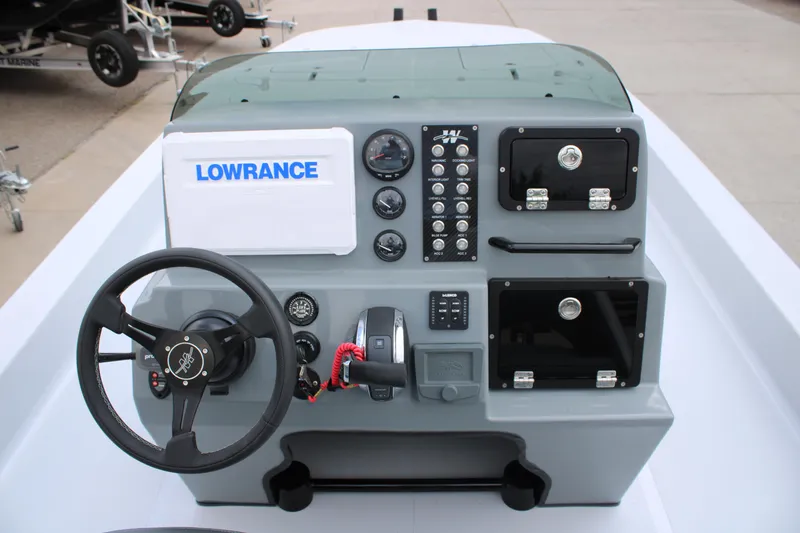 Slide: The Image of 2026 Mamba 24 Cat Elite boat dashboard with steering wheel and control panel. - 4