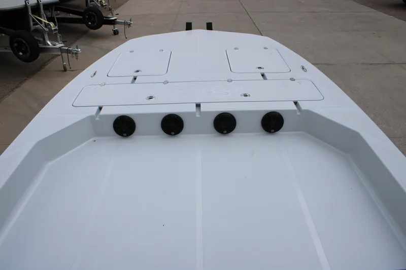 Slide: The Image of 2026 Mamba 24 Cat Elite boat deck with storage compartments and speakers. - 5