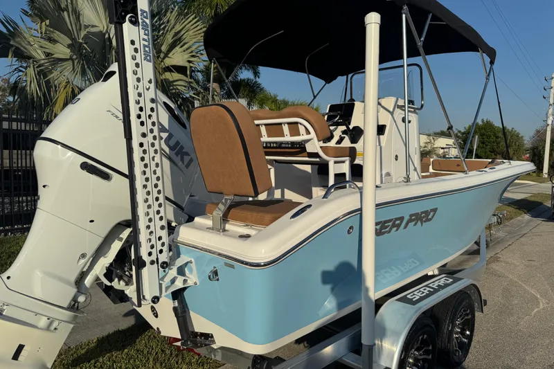 Slide: The Image of 2024 Sea Pro 202 Center Console boat with Suzuki engine, parked on a trailer. - 10