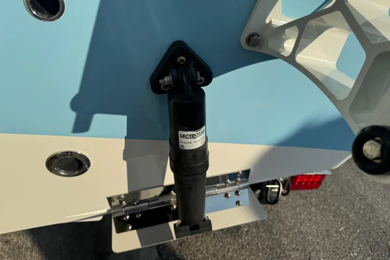 Slide: The Image of 2024 Sea Pro 202 Center Console boat detail with hydraulic component and blue hull. - 12