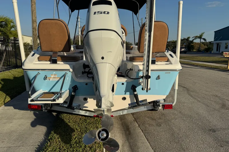 Slide: The Image of 2024 Sea Pro 202 Center Console boat, rear view with outboard motor and seating. - 15
