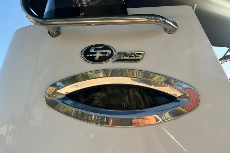 Slide: The Image of 2024 Sea Pro 202 Center Console boat with chrome logo on light blue hull. - 24