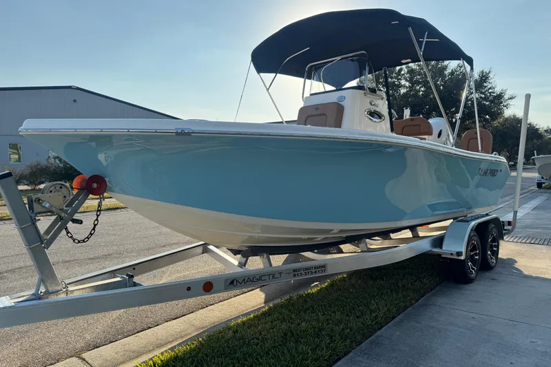 Slide: The Image of Trailer wheels of a 2024 Sea Pro 202 Center Console boat on pavement. - 25