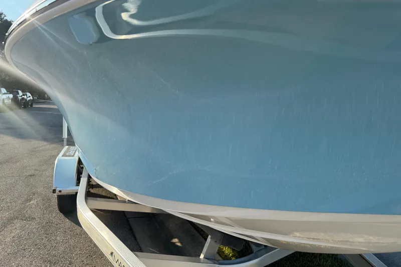 Slide: The Image of 2024 Sea Pro 202 Center Console boat on trailer with canopy, parked outdoors. - 27