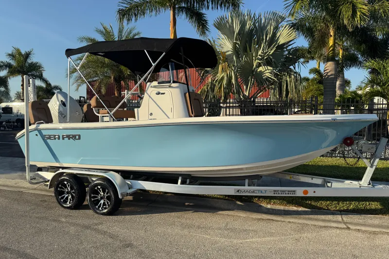 Slide: The Image of 2024 Sea Pro 202 Center Console boat on trailer, surrounded by palm trees. - 3
