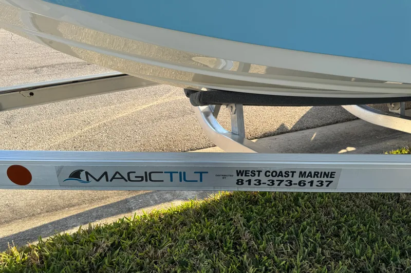 Slide: The Image of 2024 Sea Pro 202 Center Console boat on trailer, showcasing sleek blue hull design. - 34