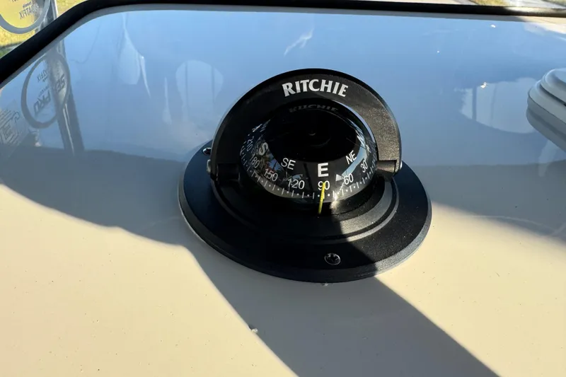 Slide: The Image of 2024 Sea Pro 202 Center Console boat dashboard with steering wheel and controls. - 38