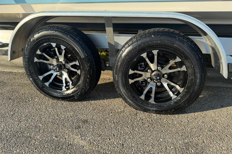 Slide: The Image of 2024 Sea Pro 202 Center Console trailer wheels on asphalt. - 5