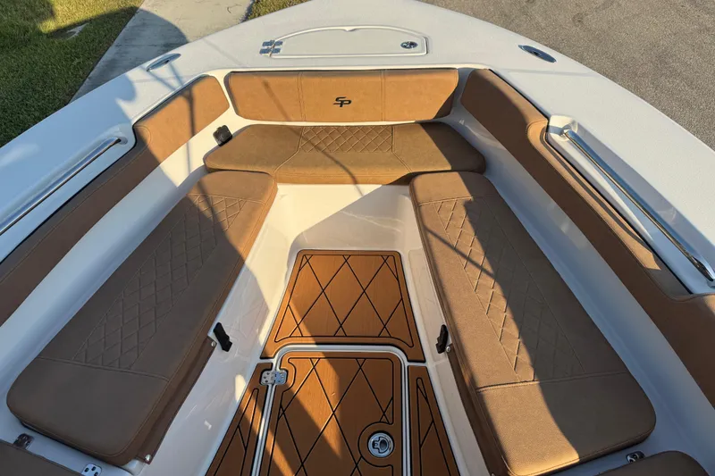 Slide: The Image of 2024 Sea Pro 202 Center Console boat interior with cushioned seating and teak flooring. - 50