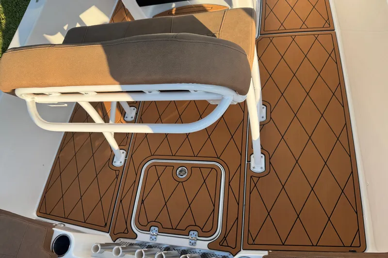 Slide: The Image of 2024 Sea Pro 202 Center Console interior with brown seating and diamond-patterned flooring. - 56