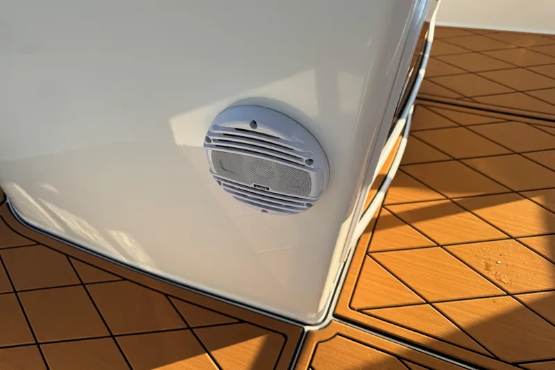 Slide: The Image of 2024 Sea Pro 202 Center Console boat deck with teak-style flooring and white railing. - 64