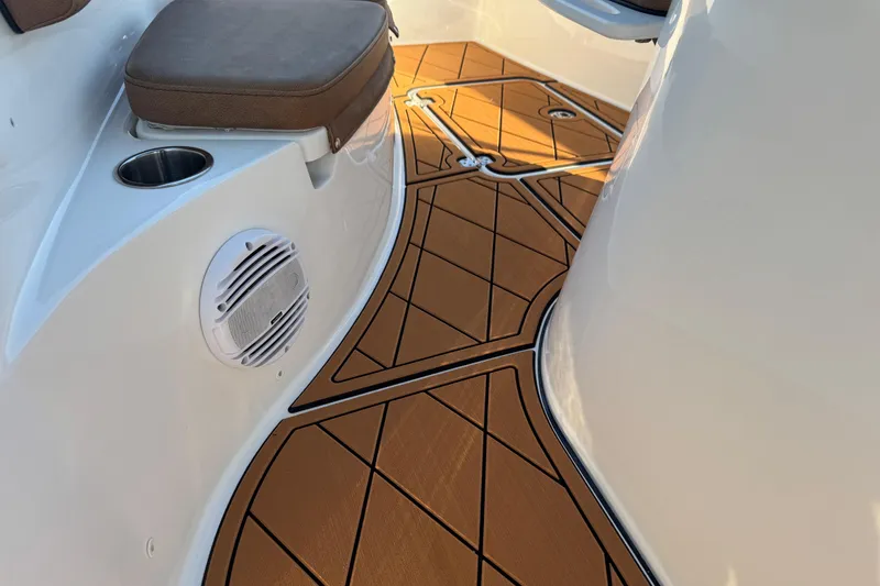Slide: The Image of 2024 Sea Pro 202 Center Console boat interior with teak flooring and capacity warning label. - 65