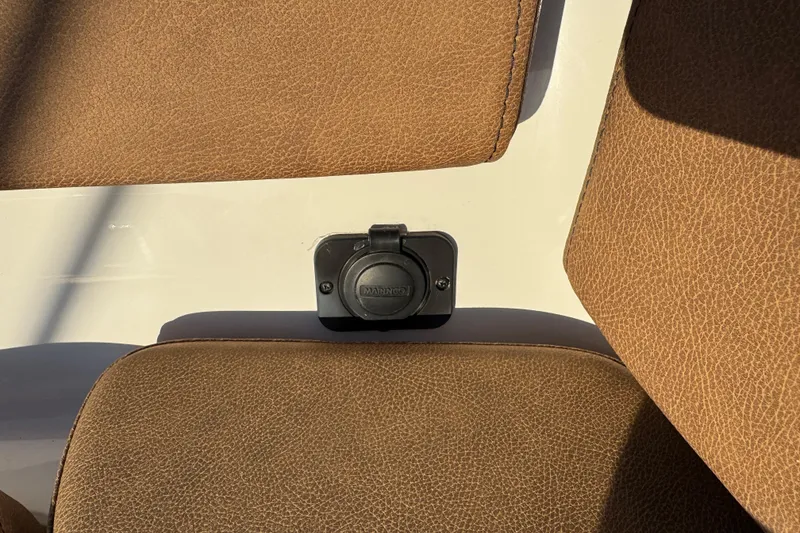 Slide: The Image of 2024 Sea Pro 202 Center Console boat dashboard with steering wheel and Simrad electronics. - 66