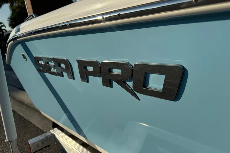 Slide: The Image of 2024 Sea Pro 202 Center Console boat, close-up of logo on light blue hull. - 7