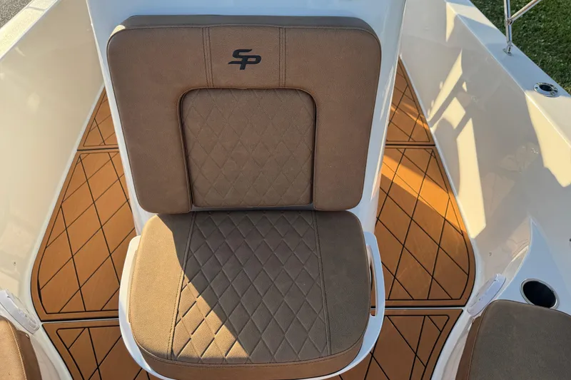 Slide: The Image of 2024 Sea Pro 202 Center Console boat with brown leather seating and a marine power outlet. - 70