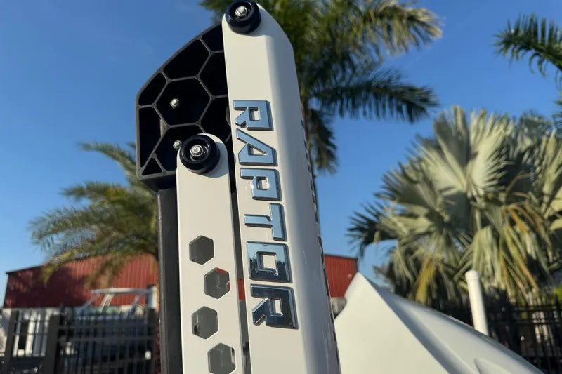 Slide: The Image of Raptor accessory on 2024 Sea Pro 202 Center Console boat, with palm trees in background. - 8