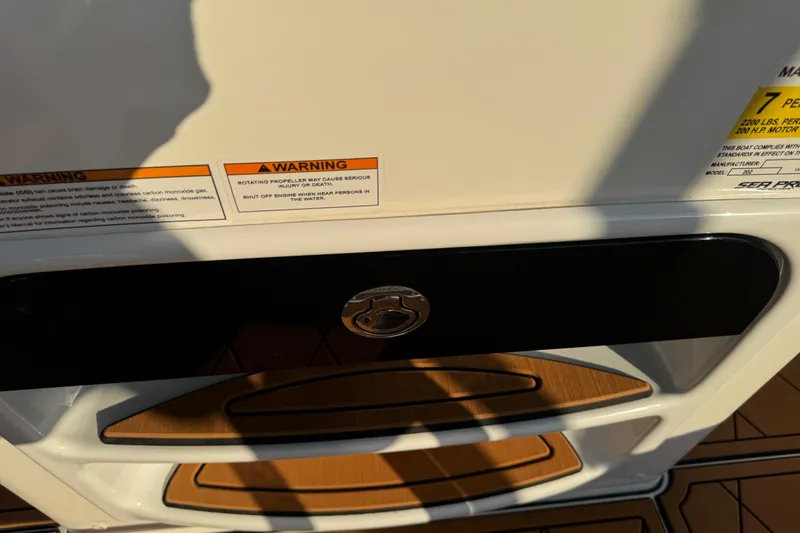 Slide: The Image of 2024 Sea Pro 202 Center Console boat interior with rod holders and cushioned seating. - 82