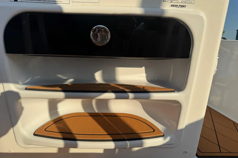 Slide: The Image of 2024 Sea Pro 202 Center Console interior detail with storage compartments and wood accents. - 88