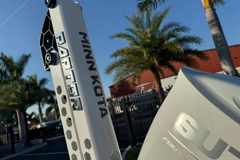 Slide: The Image of 2024 Sea Pro 202 Center Console with Minn Kota Raptor, palm trees in background. - 9