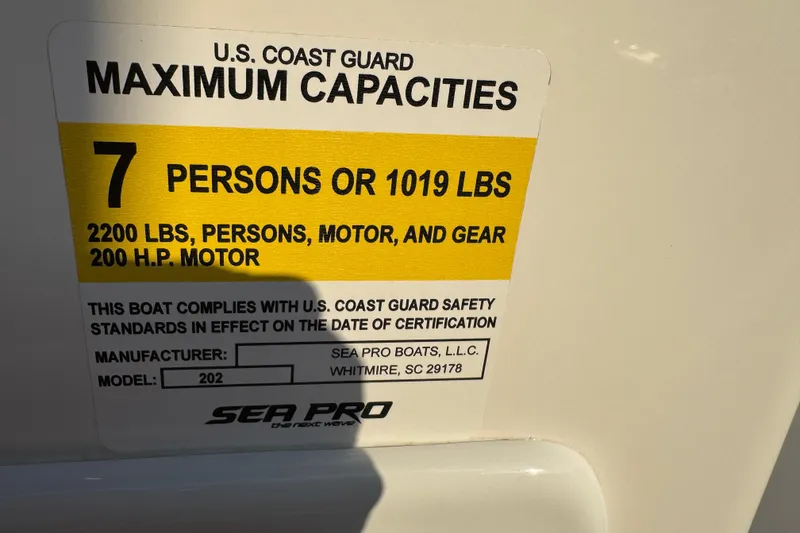 Slide: The Image of 2024 Sea Pro 202 Center Console capacity label, 7 persons or 1019 lbs, 200 HP motor. - 92