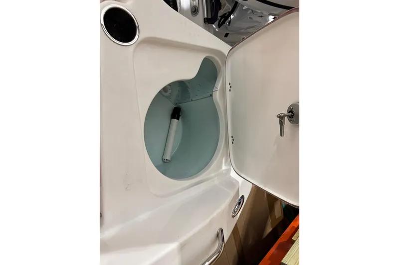 Slide: The Image of 2024 Sea Pro 202 Center Console boat storage compartment with open hatch and visible interior. - 93