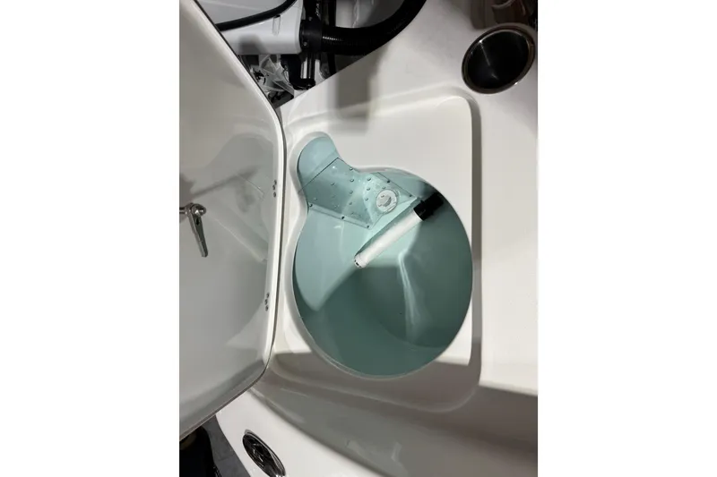 Slide: The Image of 2024 Sea Pro 202 Center Console boat's livewell with open lid, showcasing interior features. - 95