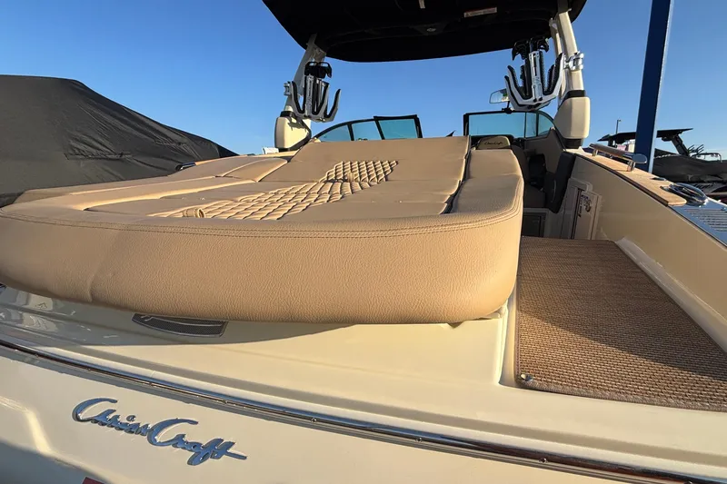 Slide: The Image of 2026 Chris-Craft Sportster 28 boat with beige seating and wooden deck details. - 11