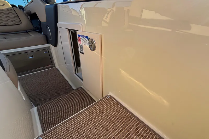 Slide: The Image of Control panel of 2026 Chris-Craft Sportster 28 boat with safety notice and QR code. - 13