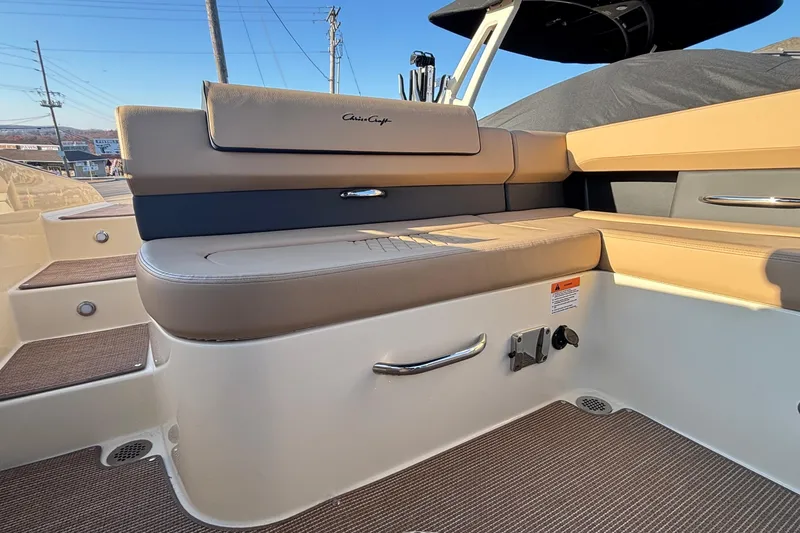 Slide: The Image of 2026 Chris-Craft Sportster 28 boat interior with beige cushioned seating. - 18