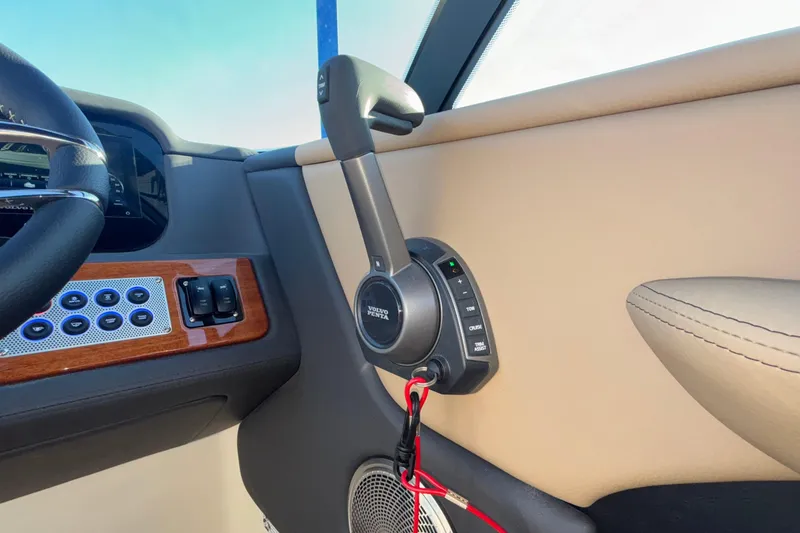 Slide: The Image of 2026 Chris-Craft Sportster 28 dashboard with ignition, warning label, and cup holders. - 33