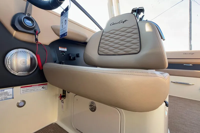 Slide: The Image of 2026 Chris-Craft Sportster 28 interior showing storage compartment under seat. - 37
