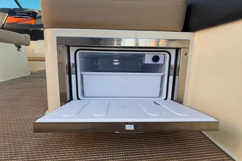 Slide: The Image of 2026 Chris-Craft Sportster 28 interior with sleek dashboard and wood accents. - 41