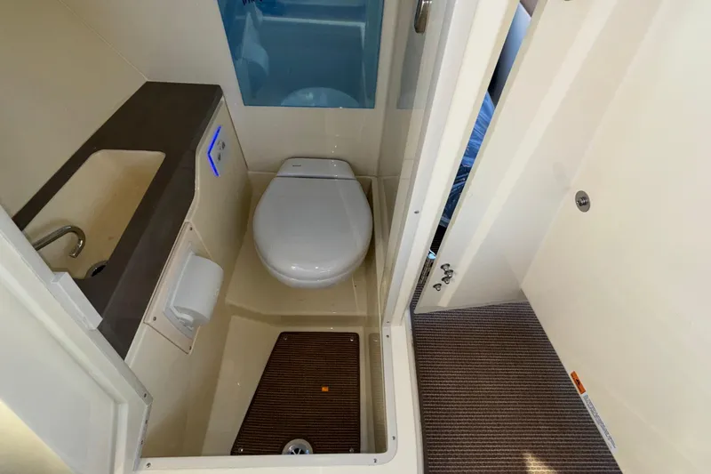 Slide: The Image of 2026 Chris-Craft Sportster 28 boat bathroom with sink and toilet. - 43
