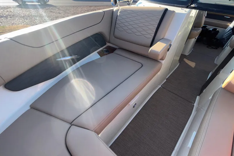 Slide: The Image of 2026 Chris-Craft Sportster 28 interior with tan leather seating and quilted design. - 56