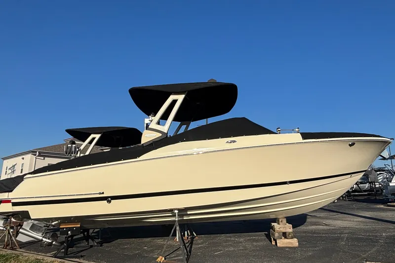 Slide: The Image of 2026 Chris-Craft Sportster 28 boat on display under clear blue sky. - 6