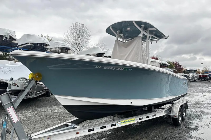 The Image of 2022 Sea Hunt Ultra 234 boat on trailer in a marina setting. - 0
