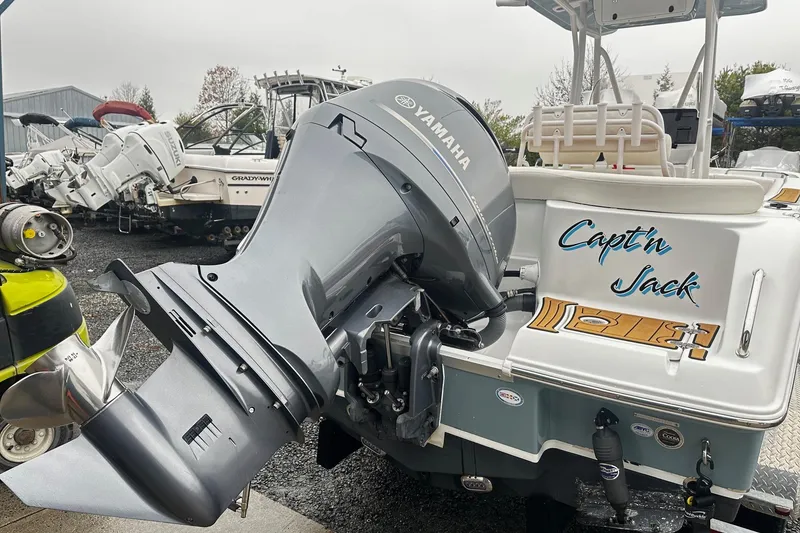Slide: The Image of 2022 Sea Hunt Ultra 234 boat with Yamaha outboard motor, labeled "Capt'n Jack." - 13