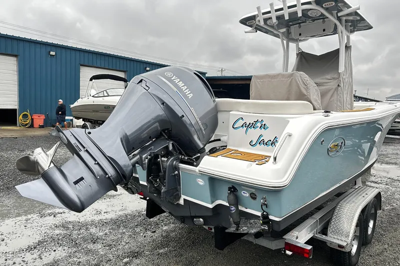 Slide: The Image of 2022 Sea Hunt Ultra 234 boat with Yamaha engine on trailer, labeled "Capt'n Jack." - 3