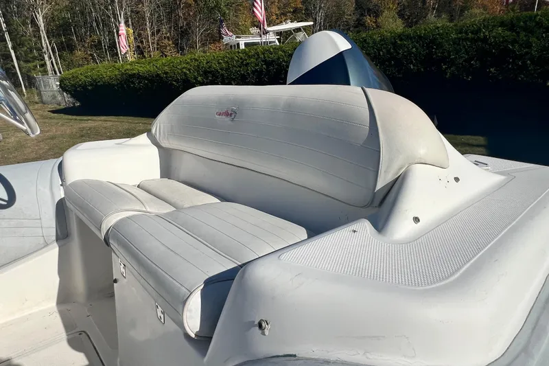 Slide: The Image of 2007 Caribe 16 boat interior with white seating and steering wheel. - 10