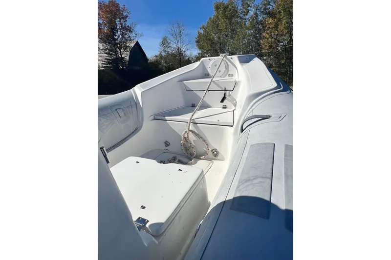 Slide: The Image of 2007 Caribe 16 boat interior with seating and rope, surrounded by trees. - 12