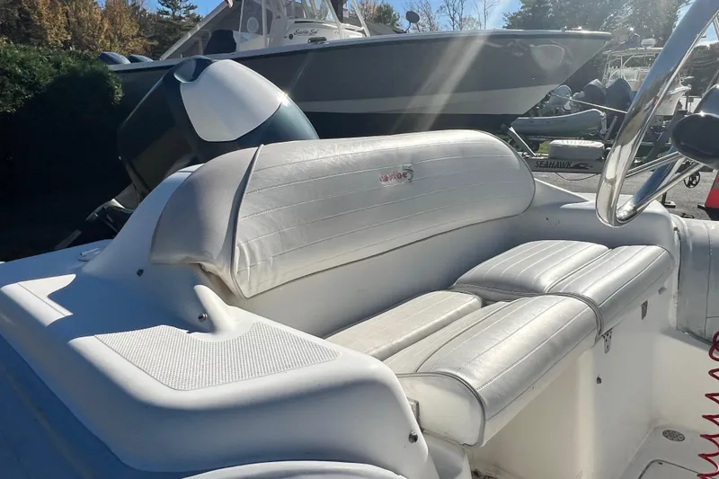 Slide: The Image of White leather seating on a 2007 Caribe 16 boat, with steering wheel visible. - 13