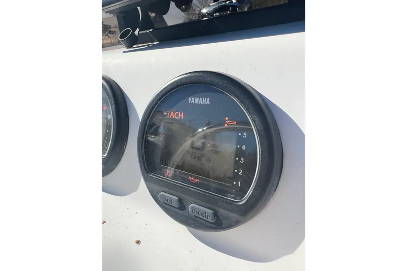 Slide: The Image of Yamaha tachometer on a 2007 Caribe 16 boat dashboard in sunlight. - 14