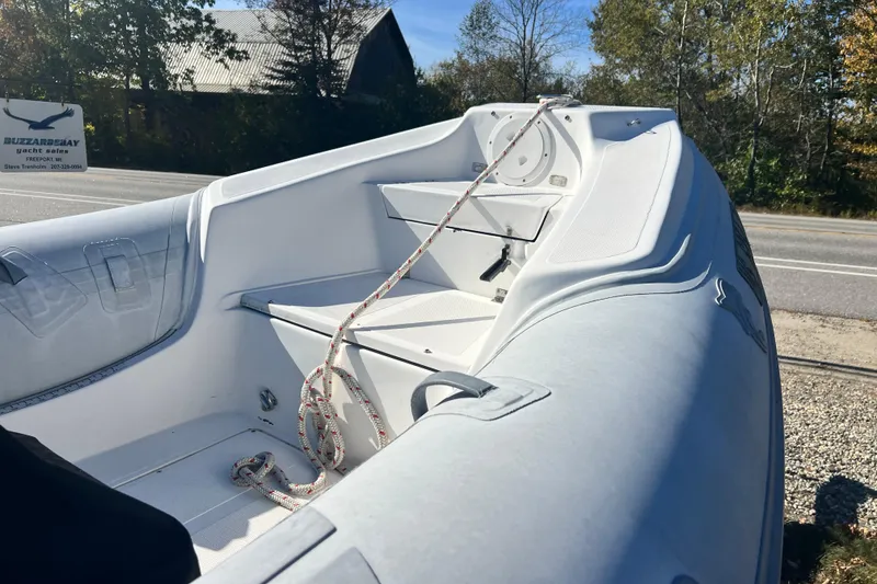 Slide: The Image of 2007 Caribe 16 inflatable boat interior with rope, parked near a road. - 15