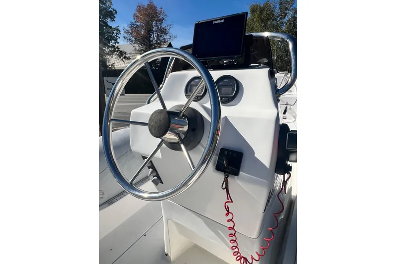 Slide: The Image of Steering console of a 2007 Caribe 16 boat with navigation equipment. - 16