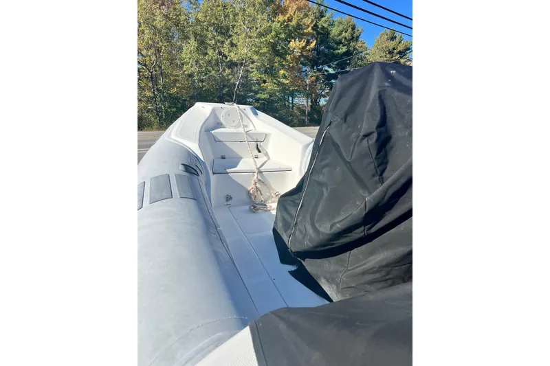 Slide: The Image of Inflatable Caribe 16 boat, 2007 model, with covered seating, outdoors. - 19