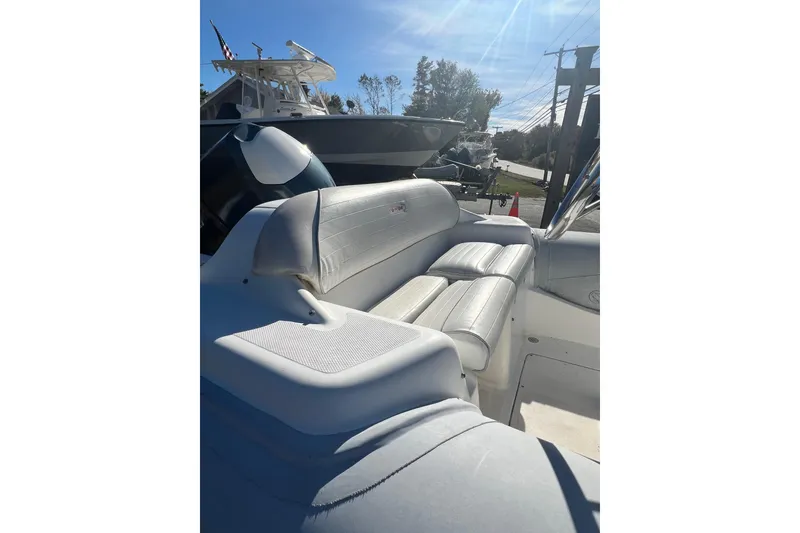 Slide: The Image of 2007 Caribe 16 boat interior with white seating and sunny outdoor setting. - 5