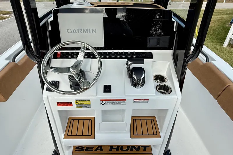 Slide: The Image of 2026 Sea Hunt Ultra 235 SE boat console with Garmin display and steering wheel. - 10