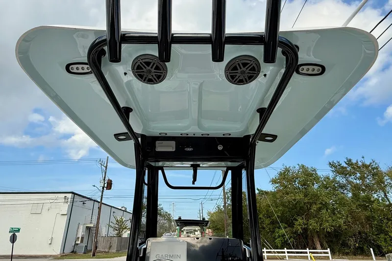 Slide: The Image of 2026 Sea Hunt Ultra 235 SE boat T-top with speakers and lights, viewed from below. - 11